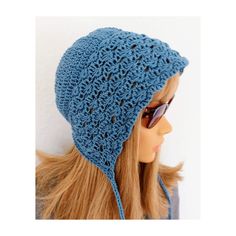 a mannequin head wearing a blue crocheted hat with sunglasses on it