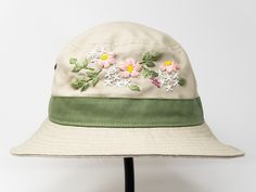 a white hat with pink flowers on it