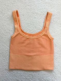 ☀Features: This Longer Length Everyday Tanktop offers a comfortable and stretchy fit that is suitable for most body types. Its versatile design makes it perfect for everyday wear, providing the utmost comfort and flexibility for any activity. Say goodbye to tight and restrictive tanktops with this must-have addition to your wardrobe. ☀Details:  Fabric: 92% Nylon / 8% Spandex Made in USA Orange Tops, Orange Tank Top, Ribbed Crop Top, Cropped Cami, Logo Collection, Dream Clothes, Long Length, Say Goodbye, Body Types