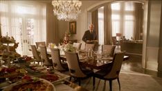 a man standing in front of a dining room table