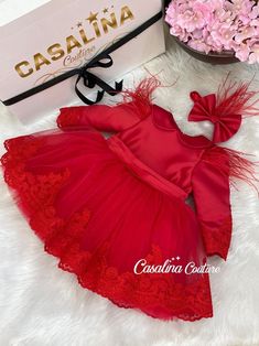 Veronica dress red. Knee-length toddler girl dress with red feather detail.Introducing the Red Knee-Length Puffed Dress with Lace Bow and Tulle Skirt for Little Girls: Perfect for Special Occasions! Get ready to dress your little princess in style with this beautiful red puffed dress. Designed with a knee-length skirt featuring a red lace bow and a tulle underskirt, this dress is perfect for those special occasions. Let me take you through the captivating features of this unique dress in this original 200-word English promotional write-up: Red Knee-Length Puffed Dress: This dress features a stunning shade of red that is both vibrant and eye-catching. The knee-length design adds a touch of elegance, making it suitable for a variety of special occasions. Lace Bow and Tulle Skirt: The dress i Fitted Winter Baptism Dress, Winter Baptism Fitted Dress, Elegant Red Dress With Feather Trim, Holiday Tulle Fitted Dress, Elegant Princess Dress For Christmas Baptism, Fitted Tulle Dress For Holidays, Elegant Holiday Princess Dress For Baptism, Red Princess Dress For Winter Wedding, Elegant Feather Trim Dresses For Dress-up