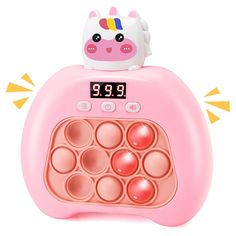 an alarm clock with a pink unicorn on it's top and the time displayed