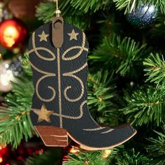 a cowboy boot ornament hanging from a christmas tree