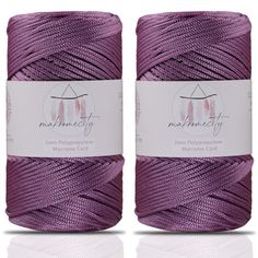 two spools of purple twine on white background