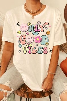 Retro Pink Printed T-shirt, Spring Fun Graphic T-shirt, Trendy Multicolor T-shirt With Text Print, Groovy Short Sleeve T-shirt With Funny Print, Spring Multicolor T-shirt With Text Print, Multicolor Funny Print T-shirt For Streetwear, Multicolor Funny Print Crew Neck T-shirt, Groovy Graphic Print Short Sleeve T-shirt, Fun Cotton T-shirt With Graphic Design