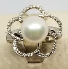 "Vintage 14K White Gold Pearl & Diamond Ring, Size 7.25. Stamped 14K JI inside band. Pearl is 8mm. No missing stones. Weighs 2.1 dwt. Please stop in often as we will be adding additional vintage fine jewelry beauties. Note that the letter/number combo in the title is for our purposes only. We do not check prongs for wear or stones for looseness. All items are sold as is-noting that we are a resale shop so everything here had a previous owner! We will include flaws in the description when not Elegant Flower Ring With Polished Finish For Anniversary, Classic White Gold Flower Ring For Formal Occasions, Classic White Gold Flower Ring For Formal Events, Elegant 14k Stamped Round Flower Ring, Elegant 14k Stamped Flower Ring, Formal White Gold Flower Ring With Polished Finish, Elegant Formal Flower Ring With Round Band, Formal White Flower Ring, Hallmarked White Gold Flower Ring For Formal Occasion