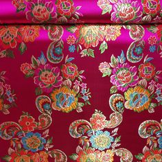 the fabric is very colorful and has many flowers on it, as well as an intricate design