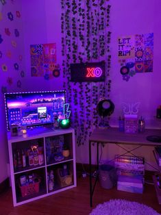 a room with purple lighting and decorations on the walls, including a computer screen that is turned on