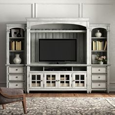 a living room with a large entertainment center