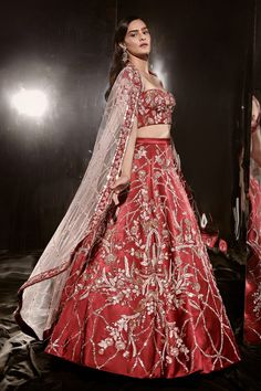 Red lehenga with attached can-can and embroidery in a checkered pattern with floral placement motifs. Comes with padded half sleeve blouse and a sheer pink border embroidered dupatta.
Components: 3
Pattern: Embroidery
Type Of Work: Cutdana and Sequin
Neckline: Sweetheart
Sleeve Type: Half
Fabric: Mashroo and Net; Lining: Shantoon
Color: Red
Other Details: 
Sheer dupatta with contrast embroidered border
Embroidered blouse with half sleeve
Occasion: Bride - Aza Fashions Red Lehenga With Sheer Dupatta In Art Silk, Red Dress For Wedding Navratri, Red Dress For Wedding And Navratri, Red Wedding Dress For Navratri, Red Sets With Sheer Dupatta For Navratri, Red Embroidered Sets For Navratri, Red Sets With Intricate Embroidery For Navratri, Red Bollywood Gown For Reception, Red Gown With Cutdana For Wedding