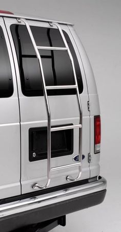 the back end of a white truck with metal bars on it's doors and windows