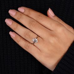 a woman's hand with a diamond ring on it