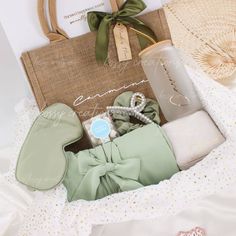 the contents of a baby's diaper are laid out in a basket on top of a bed