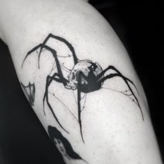 a black and white photo of a spider on the thigh