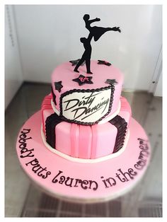 a pink cake with a figure on top