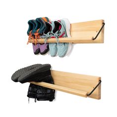 two pairs of shoes are hanging on a wooden shelf