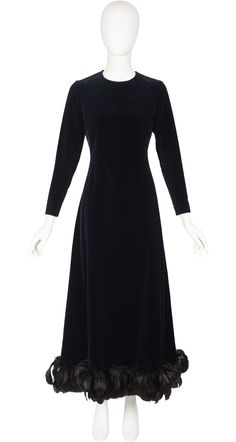 "This Givenchy Nouvelle Boutique long-sleeved evening gown is numbered, completely hand-finished demi-couture. It was made in France in the late-1960s/early-1970s of a black 78% cotton/22% viscose velvet blend, with a rayon lining and a feather trim hemline. It fastens at the back, and each cuff, with hand-set metal Eclair zippers. It's in overall very good condition. There are a few feathers missing but it's very discreet. Measurements:  Bust - 34\" Waist - 29\" Hips - 37\" Shoulders - 14\" Sle Long Sleeve Evening Dress For Fall Gala, Fall Long Sleeve Gala Evening Dress, Fall Long Sleeve Evening Dress For Gala, Long Sleeve Evening Gown For Fall, Fall Evening Dress With Fitted Bodice, Elegant Long Sleeve Dress For Fall Gala, Elegant Long Sleeve Fall Gown, Elegant Evening Gown For Fall, Formal Long Sleeve Fitted Evening Dress