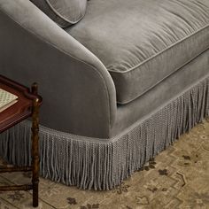 a gray couch sitting on top of a wooden table