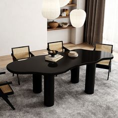 a black table and chairs in a room with white carpeted flooring, two lamps hanging from the ceiling