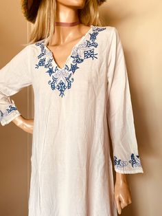 "I love this!! White cotton Blue embroidery Great condition Super light fabric Circa 1970's Measures: 36\" across chest 14\" shoulder to shoulder Hips 44\" Length 52\"" Embroidered Long Sleeve Cover-up For Vacation, Floral Embroidered Summer Cover-up For Vacation, Embroidered Spring Beach Dress Cover-up, Embroidered Beach Dress Cover-up For Spring, Spring Embroidered Beach Dress Cover-up, Floral Embroidery Cover-up For Summer Beach, Spring Embroidered Beach Cover-up, Summer Vacation Floral Embroidered Cover-up, Summer Vacation Cover-up With Floral Embroidery