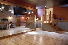 a large room with wooden floors and stairs