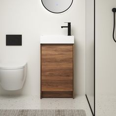 a bathroom with a toilet, sink and mirror in it's corner next to a shower