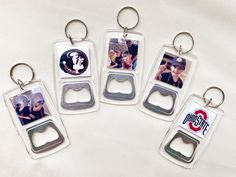 four bottle openers with pictures on them are sitting next to each other in front of a white background