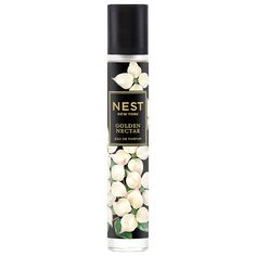 a spray bottle filled with white flowers on top of a white background and the words nest written in black