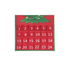 a red and green calendar with a christmas tree on it's side, in the middle