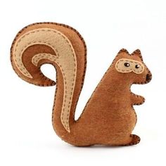 a stuffed squirrel is sitting on its hind legs and has it's tail curled up