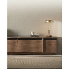 the sideboard is made from wood and has two lamps on it, one light turned on