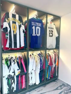 a display case filled with lots of different soccer jerseys