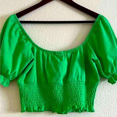 Perfect Condition. Never Worn Us 6. Elastic Smocked Waist Band And Puff Sleeves With Elastic Lining. Green Puff Sleeve Smocked Top, Trendy Green Smocked Top, Green Cotton Smocked Top For Summer, Green Smocked Back Top For Vacation, Casual Smocked Top With Puff Sleeves For Day Out, Vacation Green Smocked Top, Spring Green Top With Smocked Bodice, Spring Green Tops With Smocked Bodice, Green Tops With Smocked Bodice For Spring