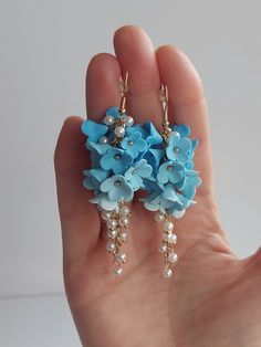 https://purplebeestudio.etsy.com Handmade unique polymer clay chandelier earrings in sky blue colour. The polymer clay flowers are made by me without using any molds. These very elegant earrings will become your favorits for many occasions day or night. Earrings made with brass ear wire. The earrings are very light and comfortable to wear all day. SHIPPING: Your order will be dispatched in a securely packed cardboard box. Product care:  - To ensure the product quality and durablility, avoid contact with water, lotion, perfumes and household cleaners and chemicals. - You can clean the products with a slightly damp soft fabric.  - Sharp objects can damage the clay surface. - When not in use, store in a dry, seperate box. Thank you for visiting my shop! If you have any special requests, I'll Clay Chandelier, Sky Blue Earrings, Sky Blue Colour, Paper Jewellery, Handmade Clay Jewelry, Handmade Jewel, Floral Jewelry, Earrings Bridesmaid, Handmade Gifts For Her