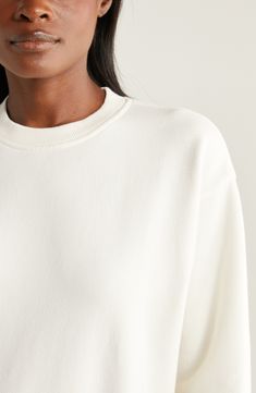 This cotton-rich fleece sweatshirt is indeed as soft as a cloud, and you'll find you're still wearing it long after you've left the gym. 22 1/2" front length; 24" back length (size Medium) Crewneck Long sleeves Ribbed cuffs and hem 72% cotton, 25% polyester, 3% spandex Machine wash, tumble dry Imported Cozy Crew Neck Sweats With Soft Texture, Athleisure Cream Crew Neck Top, Cream Crew Neck Athleisure Top, Cozy Crew Neck Sweatshirt With Soft Texture, Soft Texture Crew Neck Sweatshirt, Cotton Crew Neck Sweatshirt With Soft Texture, White Crew Sweatshirt, Cream Crew Neck Sweater For Loungewear, Cream Athleisure Tops For Loungewear