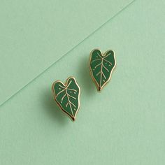 Unlike their real-life counterparts that demand high humidity and precise watering, these Alocasia earrings are wonderfully low-maintenance—providing all the drama with none of the fuss! Enamel earring with polished gold-plated metal, featuring stainless steel posts with 0.5" (13 mm) extra-long design for secure, stable wear, paired with silicone cone backs for a snug fit. Features 10x6mm full-cover, dust-proof studs. Details: One pair of stud earrings Polished gold-plated metal 0.5" tall Stainl Nickel Allergy, Enamel Earrings, The Drama, Leaf Earrings, Low Maintenance, Extra Long, Cover Design, Snug Fit, Real Life