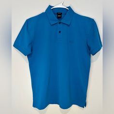 Hugo Boss Short Sleeve Polo Shirt In Xl. Made From High-Quality Piqu Cotton, This Shirt Features A Classic Collar And Button Placket. It’s Brand New But Does Not Have Tags. Ideal For A Stylish, Casual Look. Blue Polo Shirt With Collar And Buttons, Fitted Blue Button-up Polo Shirt, Classic Blue Button-up Polo Shirt, Fitted Blue Polo Shirt With Placket, Fitted Blue Polo Shirt, Blue Cotton Button-up Polo Shirt, Boss Shirts, Short Sleeve Polo, Button Placket