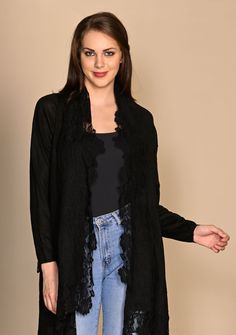 A classic black knitted long-sleeved jacket crafted from a very soft fine wool. The look of this jacket is further elevated with a tonal black floral lace border making it a unique accessory that can be worn over any casual attire or to keep stylishly warm whilst traveling. Winter Cardigan With Lace Trim For Layering, Winter Layering Cardigan With Lace Trim, Winter Lace Trim Cardigan For Layering, Elegant Spring Outerwear With Lace Trim, Elegant Lace Trim Outerwear For Spring, Winter Cardigan With Lace Trim, Fall Sweater With Lace Trim For Layering, Winter Layering Sweater With Lace Trim, Elegant Winter Outerwear With Lace Trim