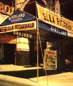 an old photo of the outside of a building with awnings on it's sides