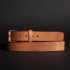 Inspired by the resilience and rugged durability of the spartans, this belt is made from 9-10oz distressed leather. This beautiful leather is aniline dyed in a drum giving it unique and vibrant colors. When the leather is stretched or pulled, the color gets lighter in the pulled areas (also called pull-up leather). Just as a Spartan wears his scars proudly, this belt will show color changes, unique marks, and a rich patina (shine) over time, ensuring that no two pieces are identical. The unique Tan Leather Belt, Leather And Brass, The Alchemist, Raw Leather, Brown Leather Belt, Suspender Belt, Distressed Leather, Leather Wraps, Suspenders