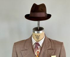 "You'll need this snazzy 1950's fedora to complete your look and turn your suit into an outfit! This fur felt fedora is chocolate brown with a cedar brown grosgrain ribbon band. It has a leather hat band and is fully lined. Made by \"Biltmore\" and sold by \"The Hat Guys\" in Oakland California. This hat is in great vintage condition with no holes, stains, or odors to note. Marked Size: 7 Inner circumference: 22\" Length (at longest point): 11.5\" Width (at widest point): 10.5\" Crown Height: 4\ Kentucky Derby Fitted Fedora, Vintage Fitted Hat Bands For Fall, Vintage Fedora For Kentucky Derby With Flat Bill, Vintage Fitted Fedora For Fall, Vintage Hat Bands For Fall, Fitted Vintage Fedora For Fall, Retro Fitted Fedora With Curved Brim, Retro Fedora With Curved Brim, Fitted Retro Fedora With Curved Brim