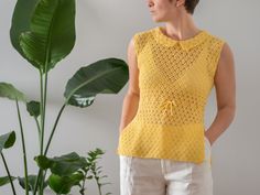 "The most adorable vintage open weave crochet top from the 1960s in stunning golden yellow colour. It seems to be a handmade piece. Open weave, sleeveless design with drawstring at waist. It features Peter Pan collar and side slits. Material: feels like cotton or a cotton blend (no tag) Condition: great vintage condition Size: best fits size XS-S, depending on desired fit (no size tag) Please compare measurements with a similar piece of your own before purchase. Measurements (taken while lying f Vintage Crochet Sleeveless Top, Vintage Sleeveless Crochet Top, Yellow Sleeveless Crochet Lace Top, Sleeveless Yellow Crochet Lace Top, Yellow Crochet Sleeveless Top, Yellow Sleeveless Crochet Top, Open Weave Crochet, Golden Yellow Color, Crochet Vintage