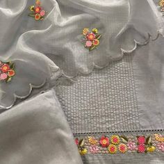 some white linens with flowers on them