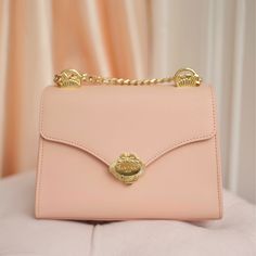 Our 'Venus' handbag is a creation inspired by the beauty and serenity of femininity. Featuring our signature 'Old World' charm, yet designed with the modern woman on the go in mind. Handcrafted from the finest Saffiano leather, the design of the gold hardware is inspired by the legend of the 'Birth of Venus', featuring a seashell motif, with a graceful bow, and a small pearl adorning the clasp. The sophisticated chain strap can be worn crossbody, or doubled-up and carried under your arm.    Resp Luxury Flap Bag With Detachable Strap For Everyday, Luxury Clutch Flap Bag For Daily Use, Luxury Flap Clutch Bag For Daily Use, Luxury Flap Bag With Detachable Strap, Elegant Satchel Shoulder Bag For Everyday Luxury, Elegant Everyday Luxury Satchel Shoulder Bag, Elegant Gold Flap Bag With Detachable Handle, Feminine Formal Shoulder Bag With Top Handle, Luxury Flap Bag As Gift