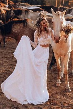 a woman in a wedding dress standing next to a horse