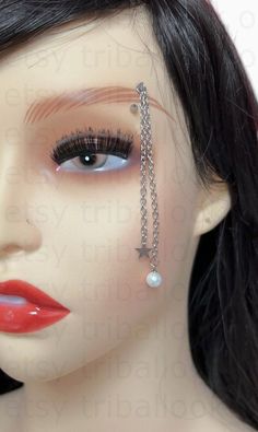 a female mannequin with fake eyelashes and chains on her face