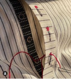 there is a piece of fabric that has been stitched into the collar of a shirt