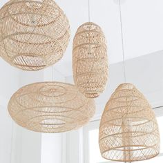 three hanging wicker lights in a white room