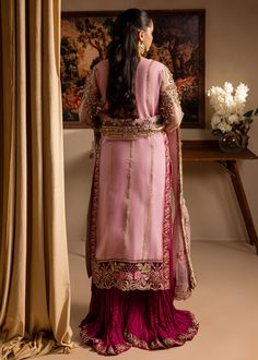 Brand: Maria Osama KhanCollection: Lamhay by Maria Osama Khan Wedding Festive Edition Fabric: Organza Description: Embroidered and hand embellished front open shirt (appliqued neckline ,sleeves, and shirt panels) Paired with crushed gharara and embroidered dupatta. Color: Pink Fabric Detail: Shirt: Organza Trouser: Pk.Rawsilk Dupatta: Organza Price Includes: Shirt Sharara Dupatta DISCLAIMER:* Lining, Laces, and Tassels are not included in unstitched variants.* Embellishment items in stitched outfits are subject to market availability.* The actual colors of the outfit may vary from the colors being displayed on your device. CARE INSTRUCTIONS: Extra Fabric Has Been Used For Shoot Original Color May Vary Slightly From The Picture Dry Clean Recommended Iron The Clothes At Moderate Temperature Diwali Hand Embellished Chinon Sets, Festive Anarkali Unstitched Suit Hand Embellished, Anarkali Style Hand Embellished Palazzo Set For Wedding, Eid Anarkali Hand-embellished Sets, Hand Embellished Unstitched Suit For Eid, Festive Hand Embellished Unstitched Suit For Eid, Eid Festive Hand Embellished Unstitched Suit, Festive Hand Embellished Unstitched Suit, Hand Embellished Semi-stitched Georgette Salwar Kameez