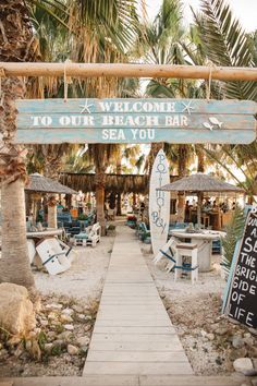 a sign that says welcome to our beach bar sea you